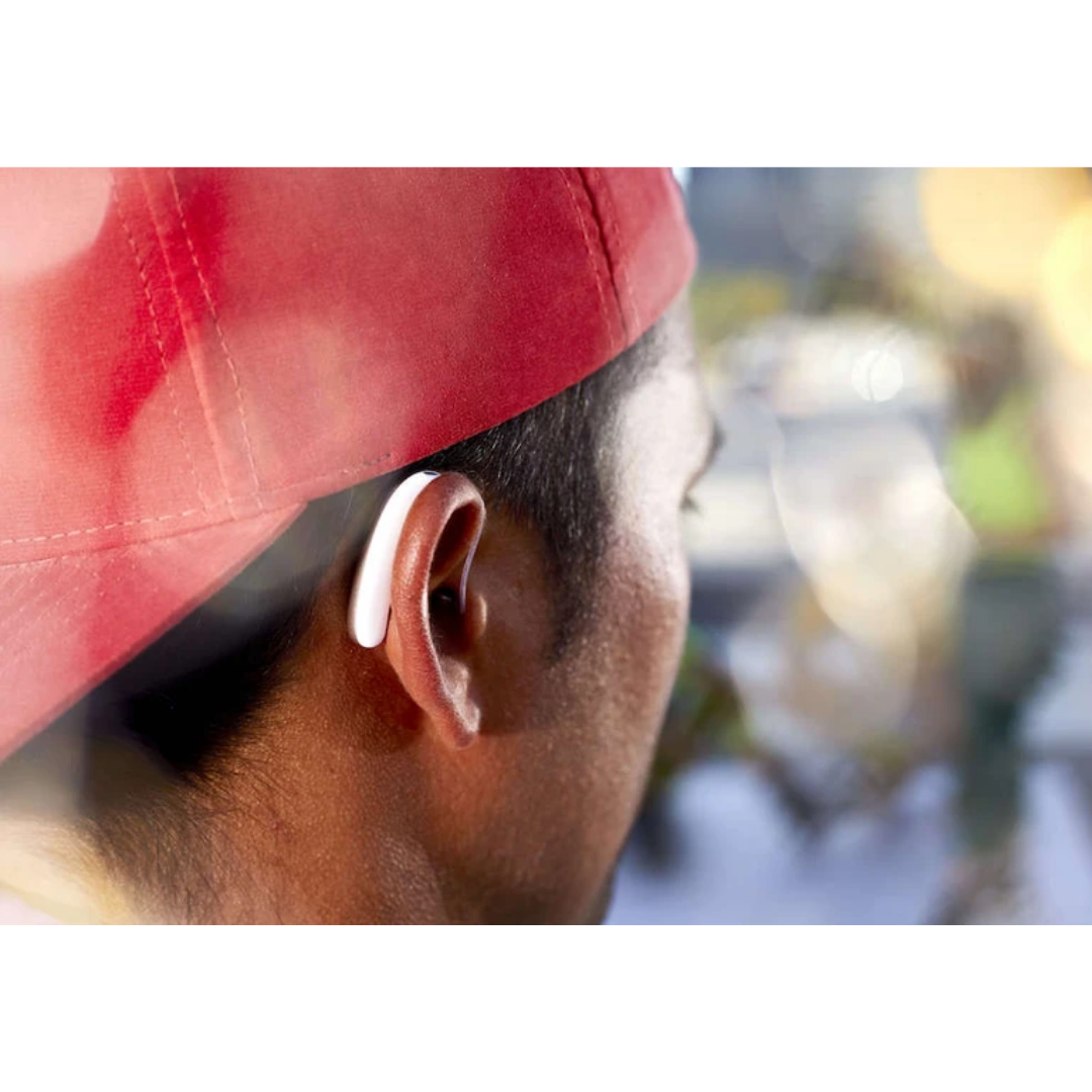 A young adult wearing highly sleek white Behind the Ear Signia Styletto 3X/7X hearing aids 